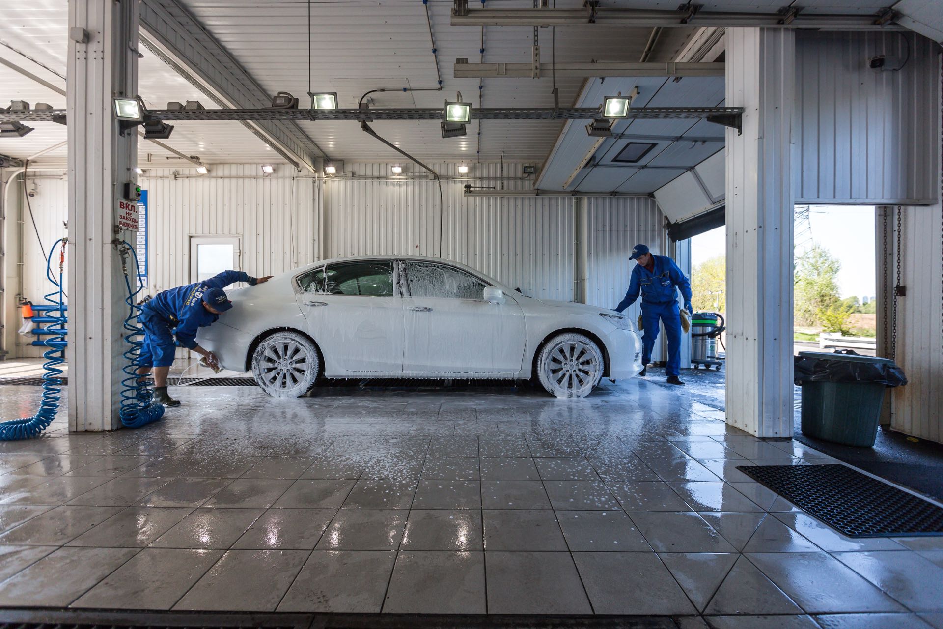 Professional detailing team from mysite-name performing paint correction on a vehicle